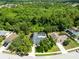 Birds-eye view of a home with a screened pool area surrounded by trees at 1014 Seminole Creek Dr, Oviedo, FL 32765