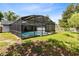 Spacious yard with a screened-in pool area and lush green lawn at 1014 Seminole Creek Dr, Oviedo, FL 32765