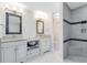 Modern bathroom featuring double vanities, linen storage, and a stylish walk-in shower with tile accents at 1014 Seminole Creek Dr, Oviedo, FL 32765