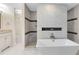 Elegant bathroom featuring a freestanding tub, walk-in shower, and white vanity with stone countertop at 1014 Seminole Creek Dr, Oviedo, FL 32765