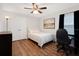 Cozy bedroom with hardwood floors, a double closet, and natural light from a window with black-out curtains at 1014 Seminole Creek Dr, Oviedo, FL 32765