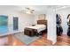 Inviting bedroom featuring hardwood floors, French doors to the backyard, and a walk-in closet at 1014 Seminole Creek Dr, Oviedo, FL 32765