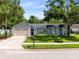 Charming single-story home with a well-maintained lawn, attached garage, and lovely landscaping at 1014 Seminole Creek Dr, Oviedo, FL 32765