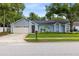 Inviting single-story home with blue siding, two-car garage, and a green, well-maintained front lawn at 1014 Seminole Creek Dr, Oviedo, FL 32765