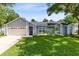 Charming single-story home with a two-car garage, blue siding, and a well-manicured lawn at 1014 Seminole Creek Dr, Oviedo, FL 32765