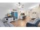 Spacious living room with hardwood floors, ceiling fan, and access to the kitchen and sliding doors at 1014 Seminole Creek Dr, Oviedo, FL 32765