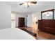 Bright main bedroom with hardwood floors, barn door access to the en-suite, and and dressers at 1014 Seminole Creek Dr, Oviedo, FL 32765
