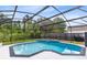 Backyard featuring a screened-in pool area with views of the wooded surroundings at 1014 Seminole Creek Dr, Oviedo, FL 32765