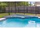 Inviting in-ground pool with spa, surrounded by a screened enclosure at 1014 Seminole Creek Dr, Oviedo, FL 32765