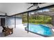 Enclosed pool area with a covered patio, wood furniture, and views of the backyard at 1014 Seminole Creek Dr, Oviedo, FL 32765