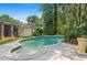 The backyard features a freeform pool and tropical landscaping, perfect for relaxing and entertaining at 102 Old Hickory, Longwood, FL 32750