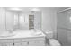 Clean and bright bathroom featuring double sinks, tile accents, and a glass-enclosed shower at 102 Old Hickory, Longwood, FL 32750