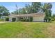 Home exterior with lawn, flowering bushes, and an American flag at 102 Old Hickory, Longwood, FL 32750