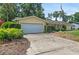 Well-maintained home exterior with mature landscaping and attached two-car garage at 102 Old Hickory, Longwood, FL 32750