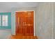 Foyer features hardwood floors, classic wallpaper, and a double door entry at 102 Old Hickory, Longwood, FL 32750