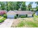 Aerial view of a single-story home with a two-car garage, tidy landscaping, and a lush green lawn at 102 Old Hickory, Longwood, FL 32750