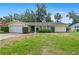 Charming single-story home with a well-manicured lawn and an American flag proudly displayed out front at 102 Old Hickory, Longwood, FL 32750