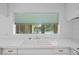 Kitchen sink with white tile backsplash, overlooking the pool outside the window at 102 Old Hickory, Longwood, FL 32750