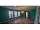 Bright living room featuring many windows with shutters and elegant chandelier at 102 Old Hickory, Longwood, FL 32750