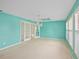 Bright living room features large windows and doors, with a decorative chandelier at 102 Old Hickory, Longwood, FL 32750