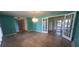 Living room features multiple windows and access to other rooms in the home at 102 Old Hickory, Longwood, FL 32750