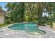 The uniquely shaped pool with lush, mature landscaping creates a private backyard oasis at 102 Old Hickory, Longwood, FL 32750