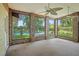 A bright sunroom with brick accents offers seamless views of the inviting pool and landscaped backyard at 102 Old Hickory, Longwood, FL 32750