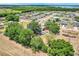 Neighborhood aerial view showcases a community surrounded by lush green space and a lake at 106 8Th St, Lake Hamilton, FL 33851