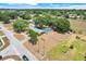 Aerial view shows a large lot with a red house, a pool, and mature trees at 106 8Th St, Lake Hamilton, FL 33851