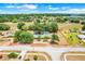 Aerial view outlines a large lot with a ranch-style home, a pool, and mature landscaping at 106 8Th St, Lake Hamilton, FL 33851