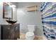 Modern bathroom with a stylish vanity, vessel sink, and a blue and white striped shower curtain at 106 8Th St, Lake Hamilton, FL 33851