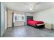 Cozy bedroom with a ceiling fan, large window letting in natural light, and neutral decor at 106 8Th St, Lake Hamilton, FL 33851