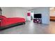 Spacious bedroom featuring tile flooring, a comfortable bed, and a modern entertainment center at 106 8Th St, Lake Hamilton, FL 33851