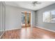 Bedroom featuring hardwood floors, neutral decor, and glass doors leading to an outdoor area at 106 8Th St, Lake Hamilton, FL 33851