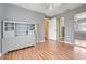 Serene bedroom features hardwood floors, a storage unit, and a mirrored sliding closet at 106 8Th St, Lake Hamilton, FL 33851
