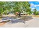 Brick ranch-style home with a long driveway, mature trees, and lush landscaping around the property at 106 8Th St, Lake Hamilton, FL 33851