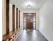 Inviting foyer featuring a front door with sidelights, tiled floor, and wooden bench with storage at 106 8Th St, Lake Hamilton, FL 33851