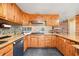 Spacious kitchen featuring wood cabinets, tile backsplash, gas range cooktop, and stainless steel dishwasher at 106 8Th St, Lake Hamilton, FL 33851