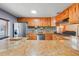 Well-lit kitchen with granite countertops, stainless appliances, mosaic tile backsplash, and wood cabinets at 106 8Th St, Lake Hamilton, FL 33851