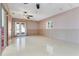 Spacious living room features tile floors, neutral paint, and direct access to a patio via glass doors at 106 8Th St, Lake Hamilton, FL 33851