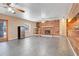Spacious living room with a brick fireplace, tile flooring, and sliding glass doors to the outside at 106 8Th St, Lake Hamilton, FL 33851
