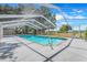 Outdoor pool surrounded by a screened-in enclosure at 106 8Th St, Lake Hamilton, FL 33851