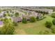 Neighborhood view with a grassy backyard, trees, and a black fence at 1089 Seburn Rd, Apopka, FL 32703