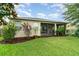 Beautiful backyard featuring lush lawn and mature trees with screened-in lanai at 1089 Seburn Rd, Apopka, FL 32703