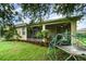 View of the home's backyard featuring a screened lanai and a jungle gym at 1089 Seburn Rd, Apopka, FL 32703