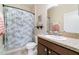 Bathroom with seashell-themed shower curtain, vanity with marble countertop, and overhead lighting at 1089 Seburn Rd, Apopka, FL 32703