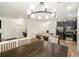 Open-concept dining area with wood floors and modern light fixture adjacent to the kitchen and a large island at 1089 Seburn Rd, Apopka, FL 32703