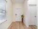 Bright entryway with hardwood floors, transom window and decorative flower vase at 1089 Seburn Rd, Apopka, FL 32703