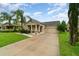Inviting single-Gathering home with a well-maintained lawn, complemented by lush palm trees and an attached garage at 1089 Seburn Rd, Apopka, FL 32703