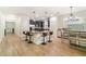 Open kitchen featuring an island with seating, stainless steel appliances, and hardwood flooring at 1089 Seburn Rd, Apopka, FL 32703